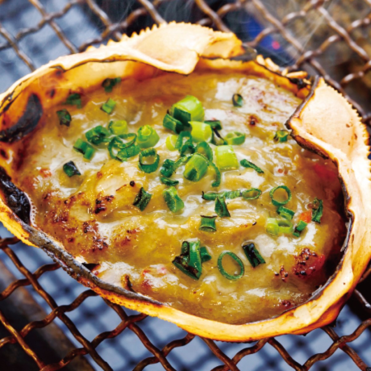 Crab miso grilling in its shell at Isomaru Suisan
